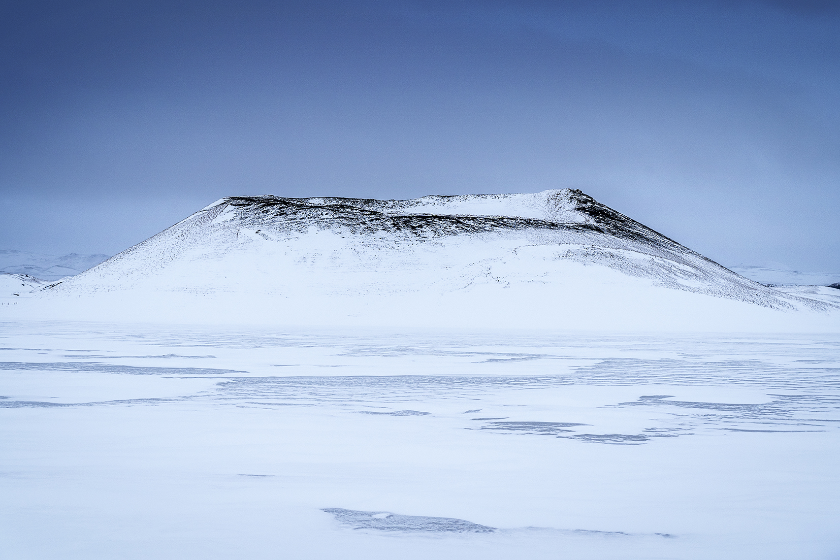 Mývatn Skútustaðagígar volcans enneigés ciel noir vent lac gelé